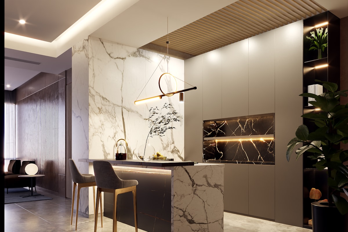 A contemporary kitchen with an island bench, stone benchtop and full-height cabinetry